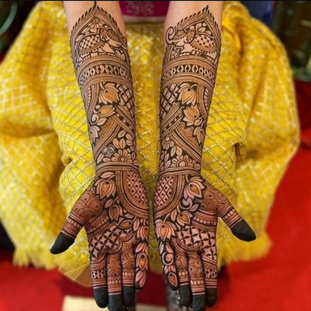 A person applying henna on another person's hand